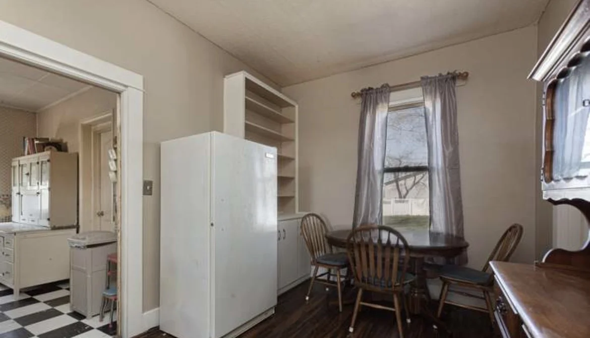 Dated dining room with built-in shelving before the remodel