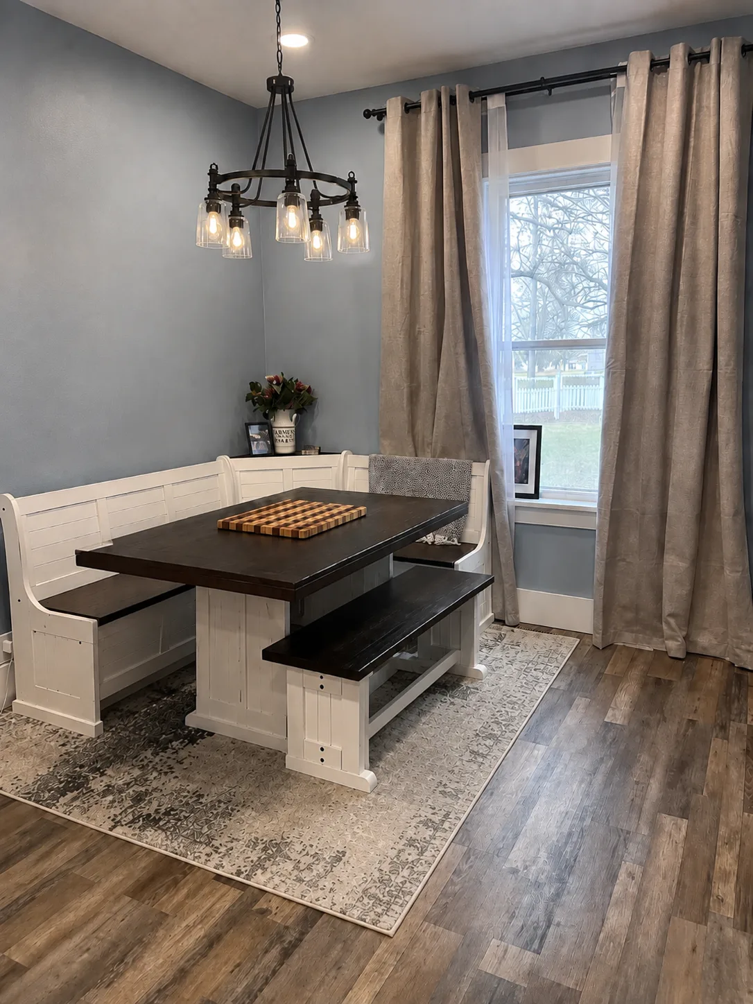 Dining nook with new plank floor and iron chandelier