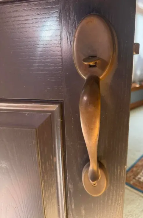 Old brass handleset on the interior side of the door