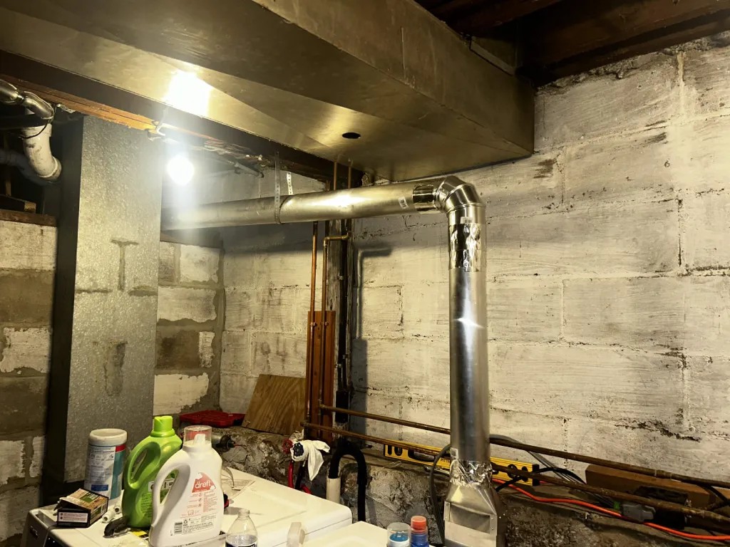 Rigid duct routed along the basement ceiling
