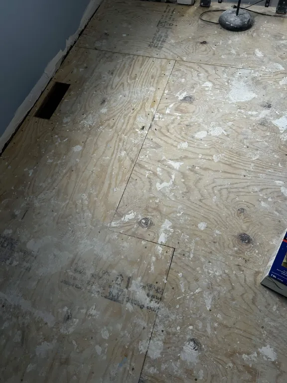 Bare plywood subfloor prepped for new flooring