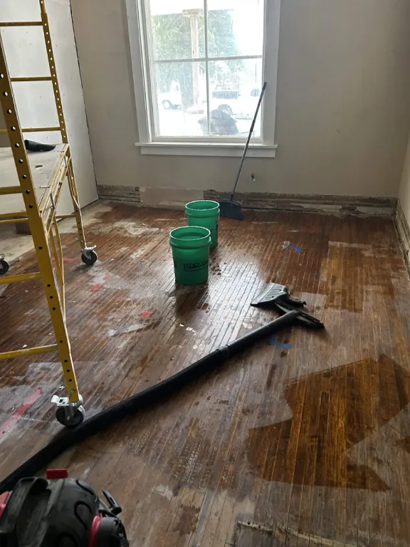 Old hardwood floor being stripped and cleaned