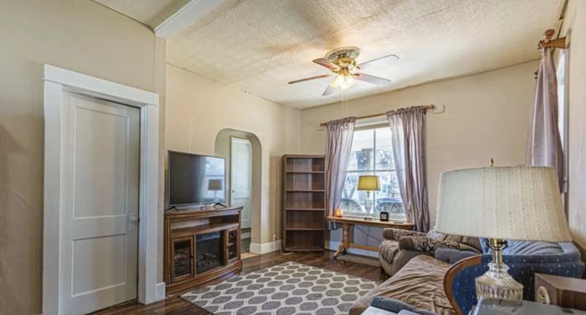 Dated living room with textured ceiling before the remodel
