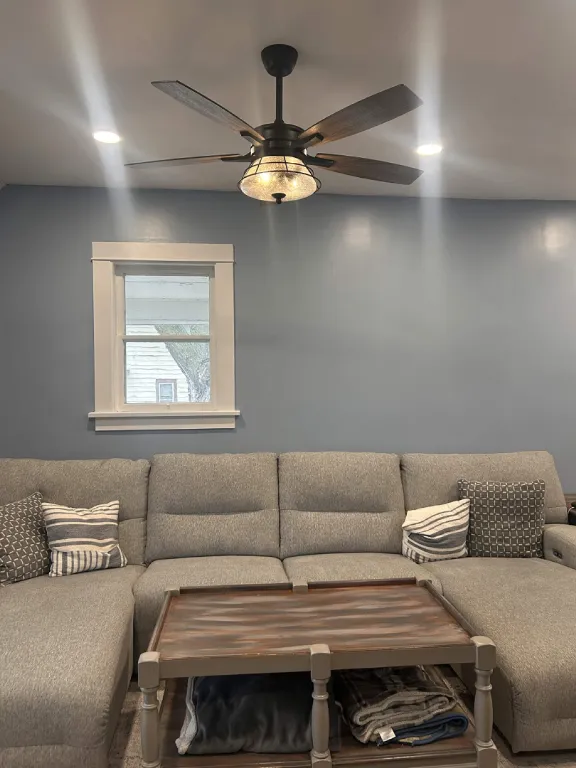 Finished living room with painted walls and ceiling fan