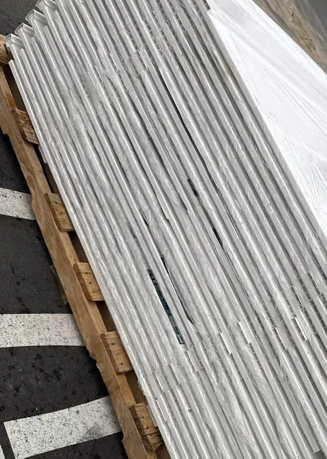 Pallet of wrapped white PVC fence panels
