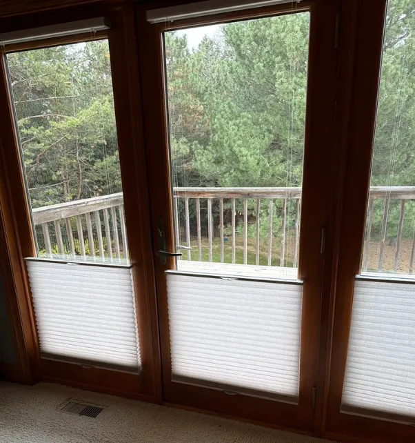 Wood patio door with sidelights opening onto a deck
