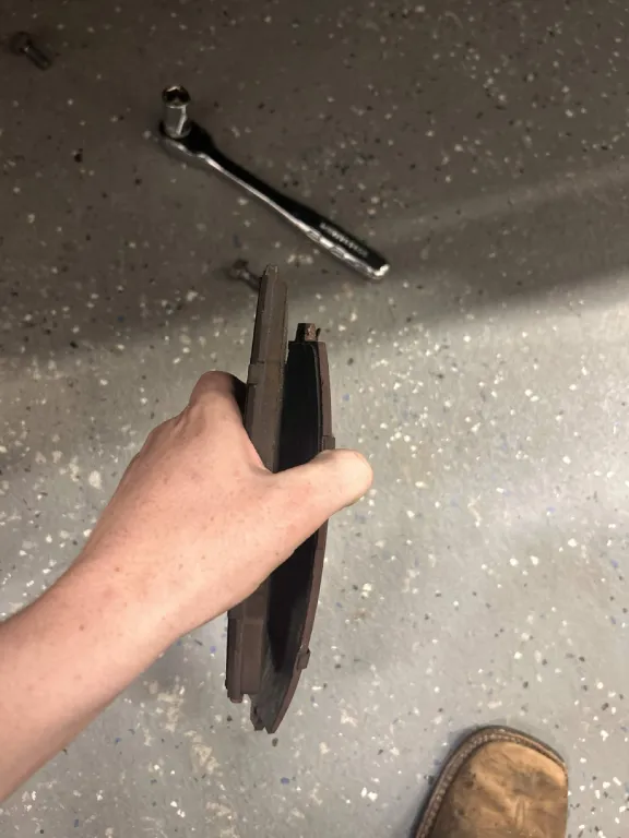 Used brake pads removed during a brake service