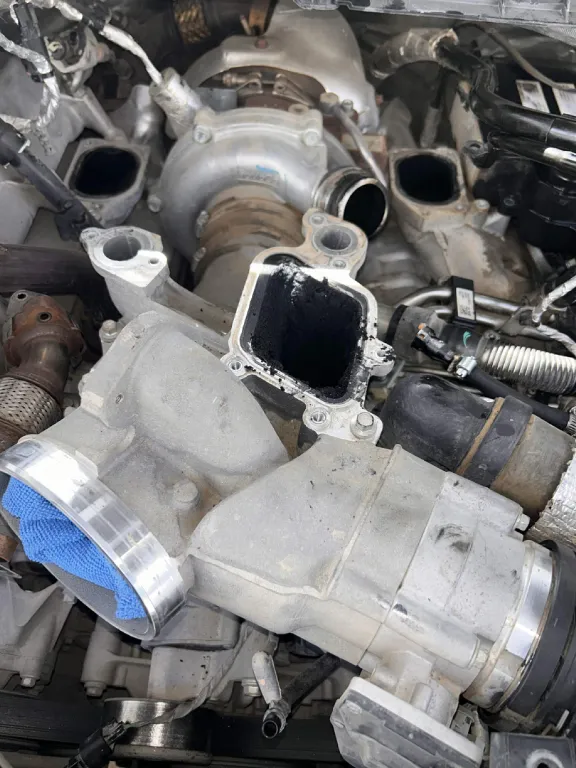 Diesel intake manifold removed showing carbon buildup