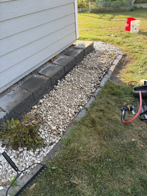 Bed cleared and fresh rock laid along the foundation