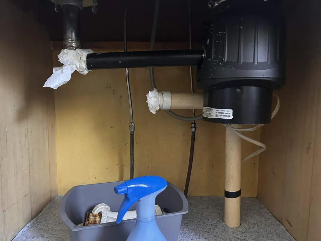 Old under-sink drain plumbing before the repair